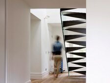 Metal designer staircase in purist foyer