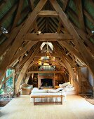 Renovated roof timbers with living room with impressive old wood construction