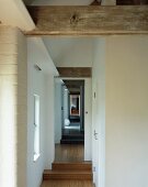 Long hallway with a landing in a converted barn