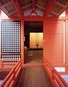 Traditional, Japanese home with bright red lacquered door and view of floor mats