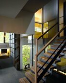 Open stairwell in contemporary house with interior and exterior views