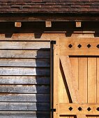 Rustic wooden door in front of weathered wooden house facade