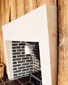 Brick fireplace and wall with wooden cladding