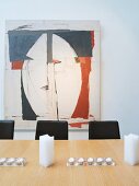 Large painting behind dining table