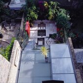 View onto terrace with floor of glass panels and second terrace level with stone flagged floor