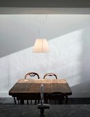 Rustic wooden dining table & chairs with modern pendant lamp