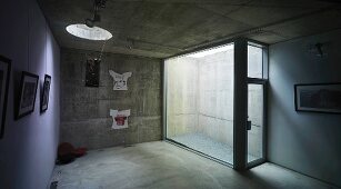 Cellar with concrete walls, round skylight & glass emergency exit