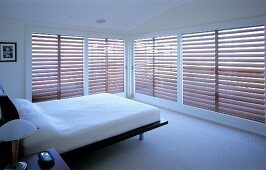 Bedroom with large windows and blinds
