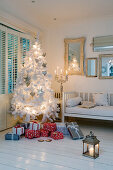 Christmas atmosphere - white Christmas tree and presents in corner of country-style interior