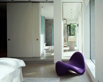 Violet designer couch in bedroom with ensuite bathroom