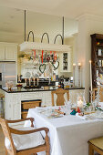 Set dining table in open-plan country house kitchen