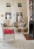 Armchair with white leather upholstery and sofa made of bamboo poles in modern country house