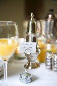 Orange juice and place card on set breakfast table