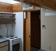 Functional kitchen with open wooden sliding door