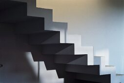 Pattern of light and shade on cubic, zigzag staircase without balustrade