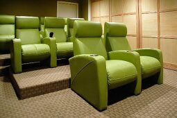 Three rows of green cinema seats