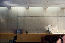 Wooden sideboard against concrete wall in contemporary house