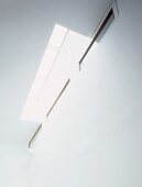 View from below of skylight in ceiling with window slits in white wall