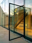 Open glass door leading to terrace of contemporary apartment building