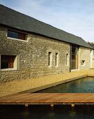 Renovated farmhouse with stone facade and water-filled pool