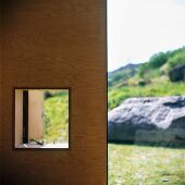 Wooden wall with window aperture and view of landscape