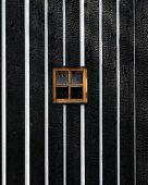 Black and white wooden wall with small window