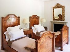 Antique twin beds in bedroom with fireplace