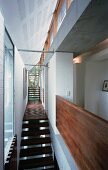 Narrow stairwell with wooden stairs in contemporary house