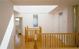 Landing with large skylight in roof and openings to lower storey with traditional wooden balustrades