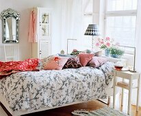 Inviting bedroom with patterned bed linen and scatter cushions