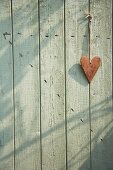 Heart hanging on a wooden door