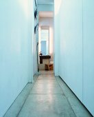 Simple, narrow corridor with concrete floor