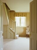 View through open double doors into bright stairwell of country house