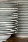 A close-up of two stacks of white plates