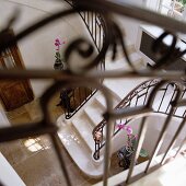 View down onto marble staircase with wrought iron balustrade in foyer of Mediterranean villa