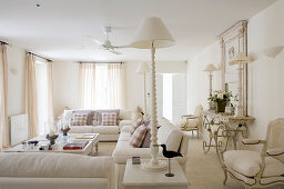 White country house living room with modern sofa set and antique pieces of furniture