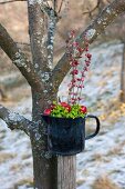 Arrangement of moss, crab apples and pink snowberry flowers