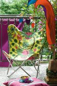 Pennants and colourful butterfly chair on summery balcony