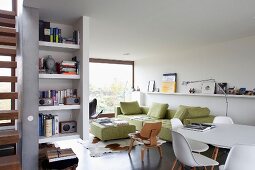 Light-flooded living-dining room with lime-green sofa set and white Eames dining set