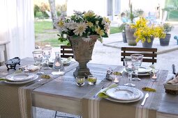 Festively set table on terrace with view of courtyard