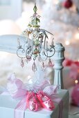 Present prettily wrapped with ballet shoe baubles beneath vintage miniature chandelier