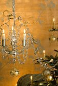 Chandelier and Christmas tree in front of gold wall with tendril-motif wall stickers