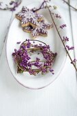 Wreath of callicarpa berries and Christmas biscuits in white dish