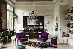 Chairs with purple velvet upholstery in elegant salon with stucco mouldings