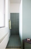Grey tiled shower area in minimalist bathroom