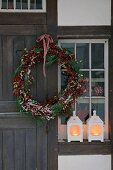 Front door with Christmas wreath and windlights
