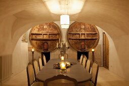Elegant, candlelit dining area in old wine cellar with barrel vault ceiling
