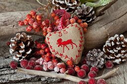 Christmas arrangement with embroidered, heart-shaped cushion