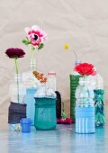 Plastic bottles decorated with remnants of stockings and used as vases