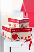 Red tape and tape with apple motif on small gift boxes